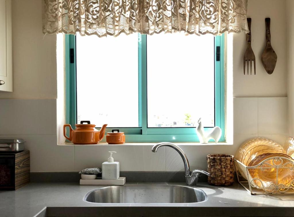 a kitchen with a sink and a window at יעלת חן Ya'alat hen in Yeroẖam