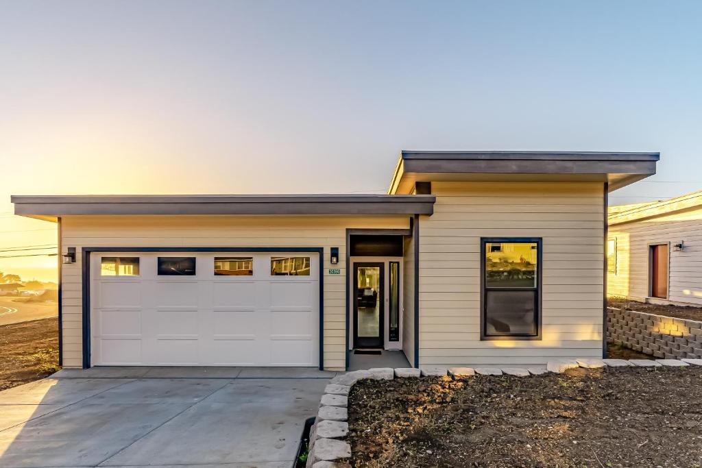 a house with a white garage door at Pacific Breeze in Gold Beach