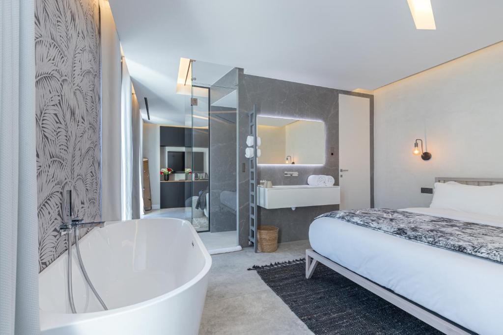 Postel nebo postele na pokoji v ubytování Le Dortoir Boutique Suites