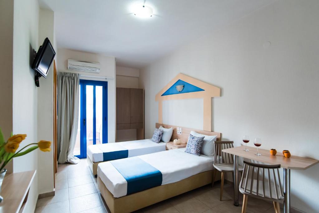 Postel nebo postele na pokoji v ubytování Ilios Malia Hotel Resort