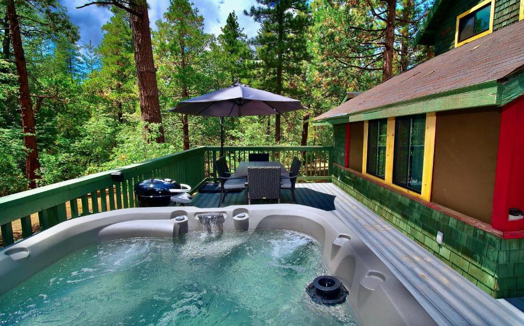 a hot tub on the deck of a house at Peaceful Cabin in Idyllwild