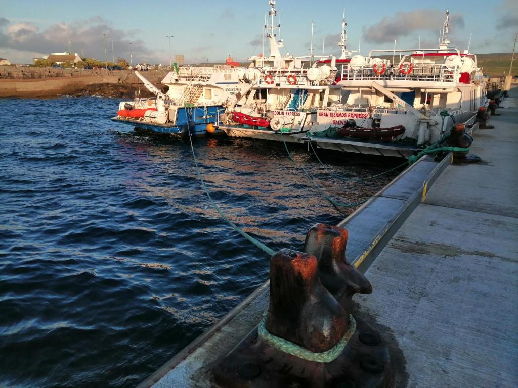 two boats docked at a dock in the water at Puffin rooms in Lisdoonvarna