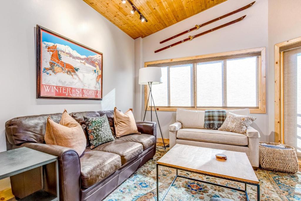 a living room with a couch and a table at Deer Valley Courchevel Condo in Park City