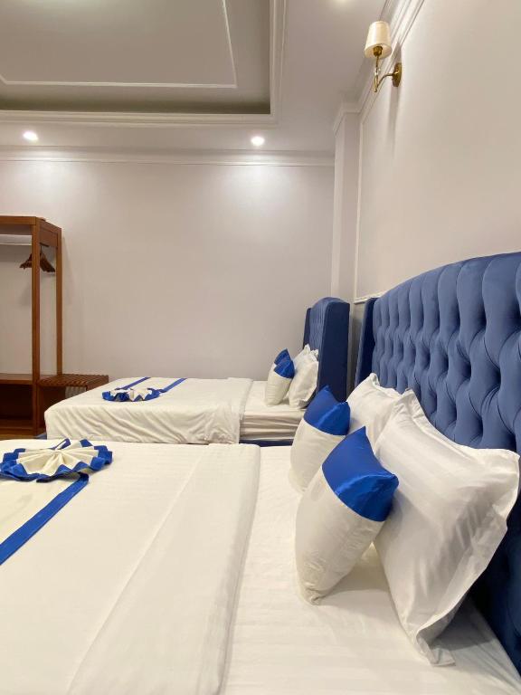 Postel nebo postele na pokoji v ubytování Peach Valley Hotel Dalat