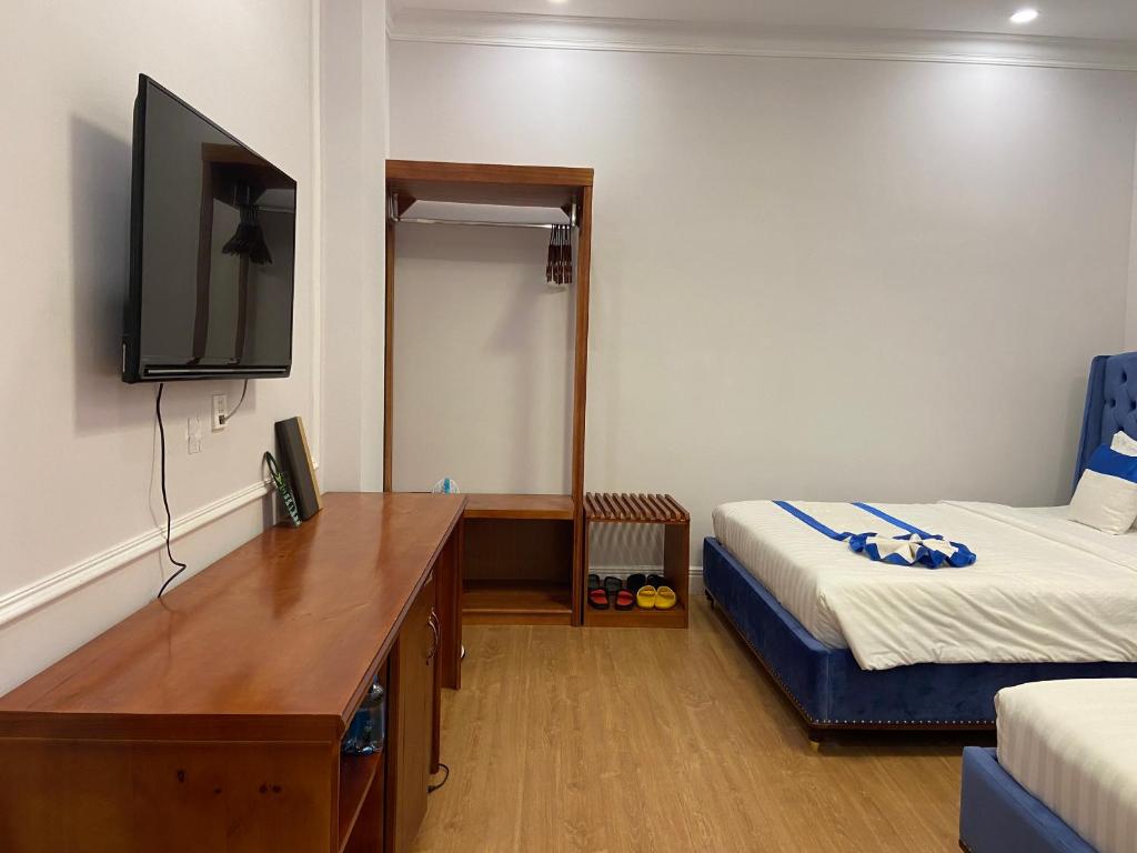 Postel nebo postele na pokoji v ubytování Peach Valley Hotel Dalat