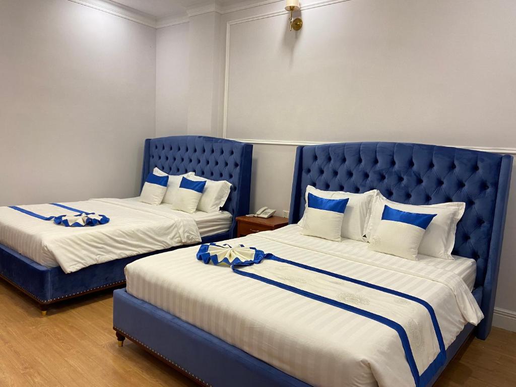 Postel nebo postele na pokoji v ubytování Peach Valley Hotel Dalat