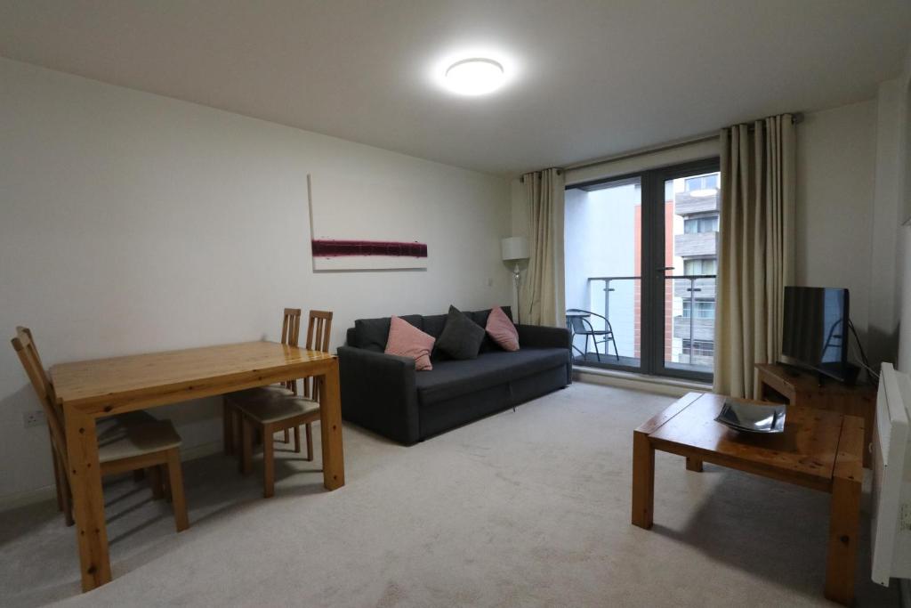 a living room with a couch and a table at Apartments at Granville in Birmingham