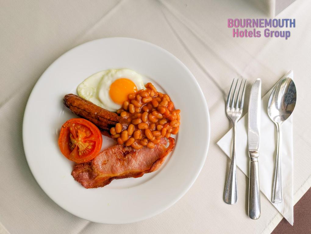 a plate of breakfast food with eggs beans and bacon at The Grove Hotel in Bournemouth