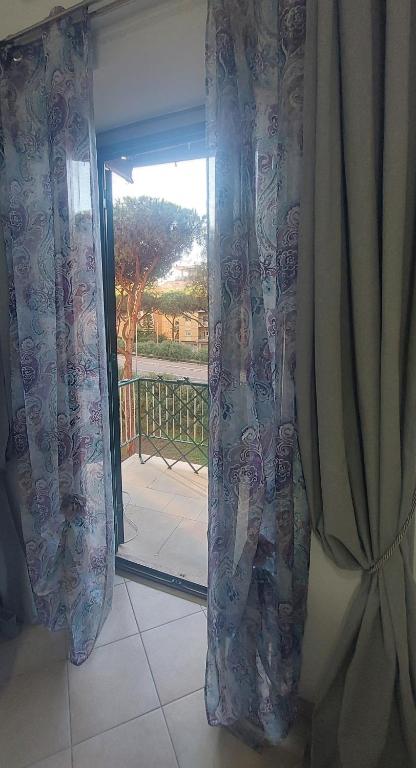 Pokój z przesuwnymi szklanymi drzwiami prowadzącymi na patio. w obiekcie Sweet Home w mieście Lido di Ostia