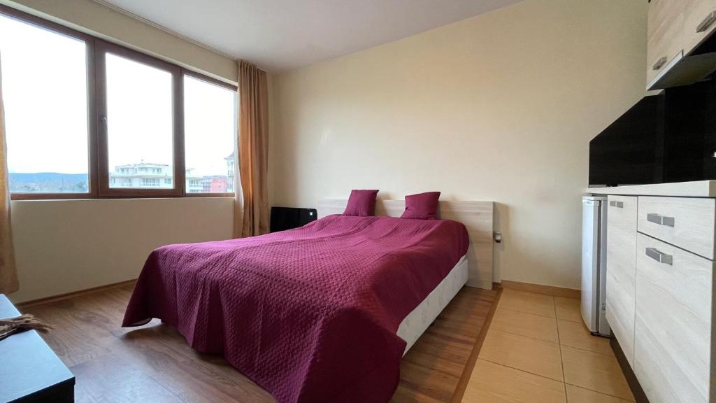 A bed or beds in a room at SUMMER BREEZE 406 Studio Sunny Beach