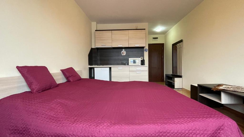 A bed or beds in a room at SUMMER BREEZE 406 Studio Sunny Beach