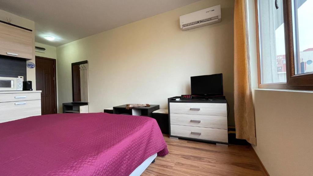 A bed or beds in a room at SUMMER BREEZE 406 Studio Sunny Beach