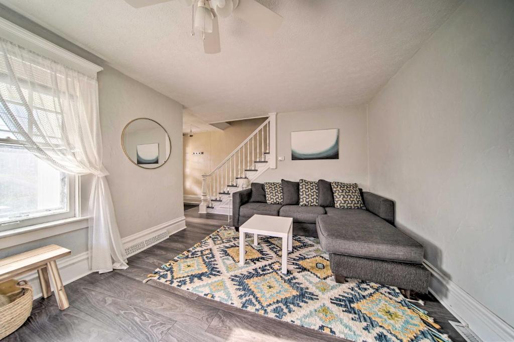 a living room with a couch and a table at Historic Family Home 2 Mi to Lake Erie and Zoo! in Erie