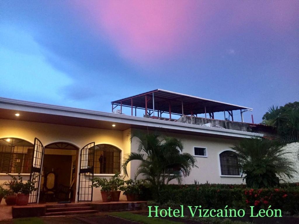 a building with a solar roof on top of it at Hotel Vizcaíno León in León