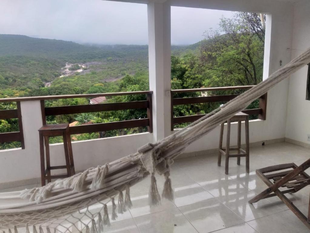 倫索伊斯的住宿－casa de Luciana - Lençóis，客房设有带吊床的阳台,享有美景。