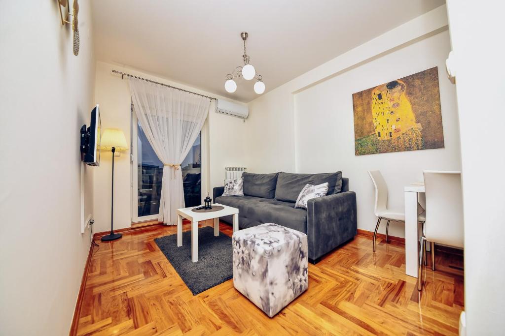 a living room with a couch and a table at Apartman A9 Lux in Banja Koviljača