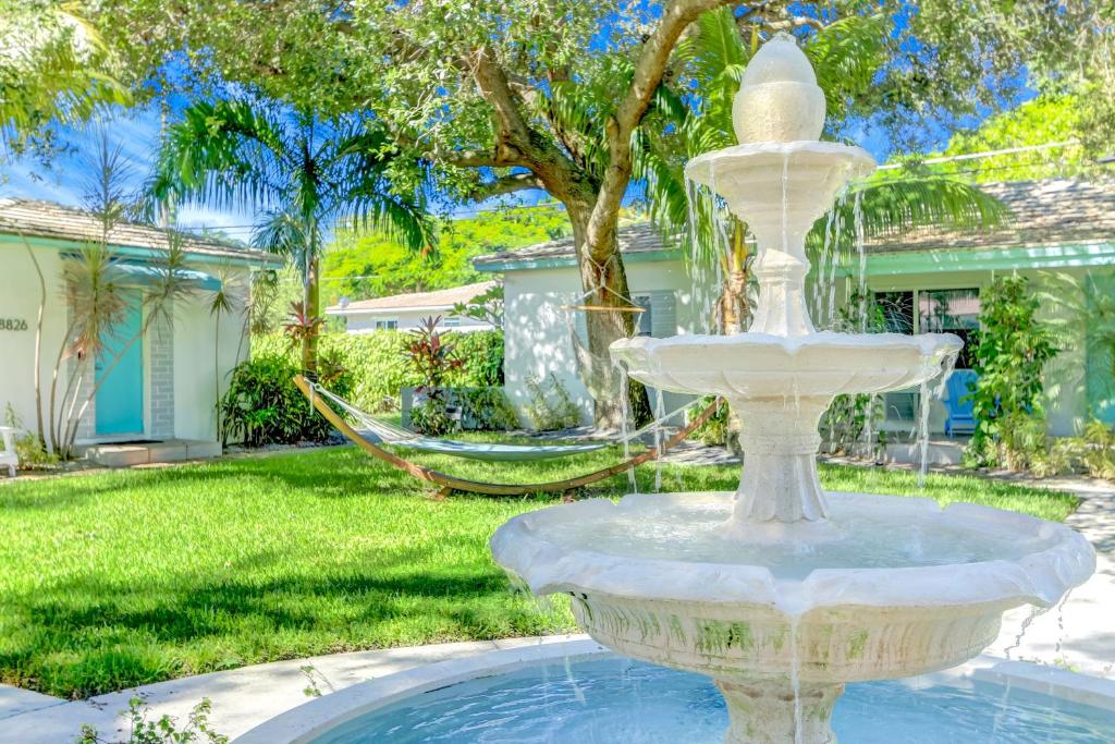 a large white fountain in a yard with a hammock at Cottages El Portal in Miami