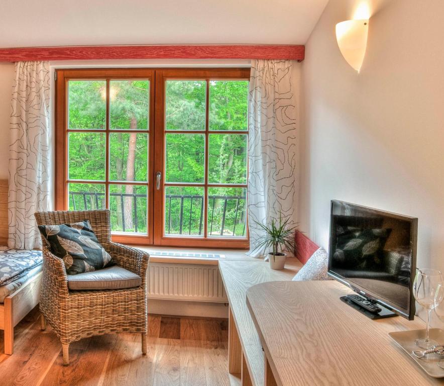 a living room with a table and a window at Statek Samsara in Blansko