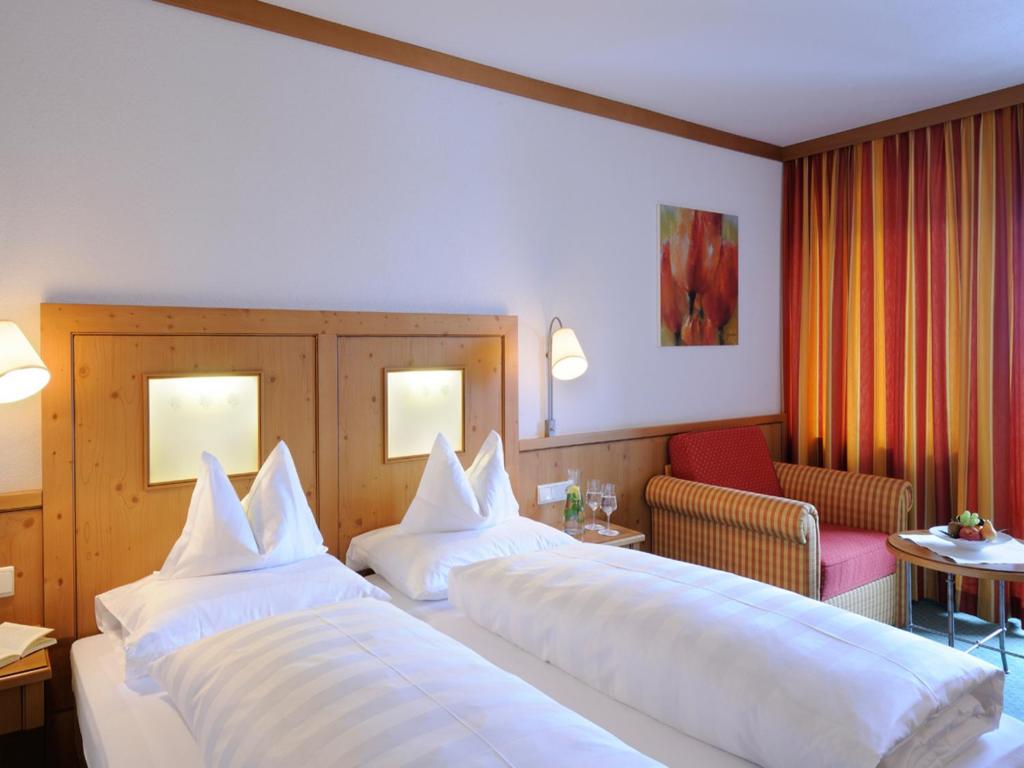 Postel nebo postele na pokoji v ubytování Cresta.Alpin.Sport.Hotel