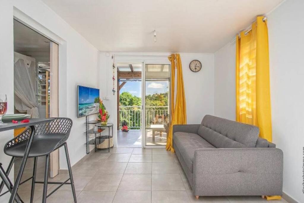 a living room with a couch and a table at Appartement Grenade, Idéal Famille, Jardin Privatif, Piscine in Abondance