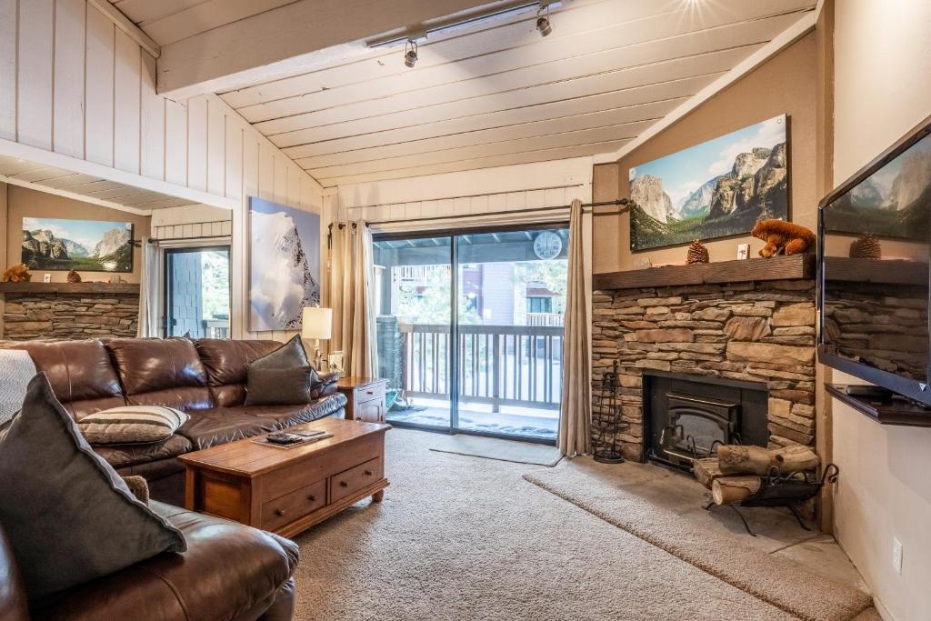 a living room with a couch and a fireplace at New Listing 2 bedroom and Loft 2 bath Summit E Bldg 16 condo sleeps 8 Steps to Eagle Lodge Chair 15 in Mammoth Lakes