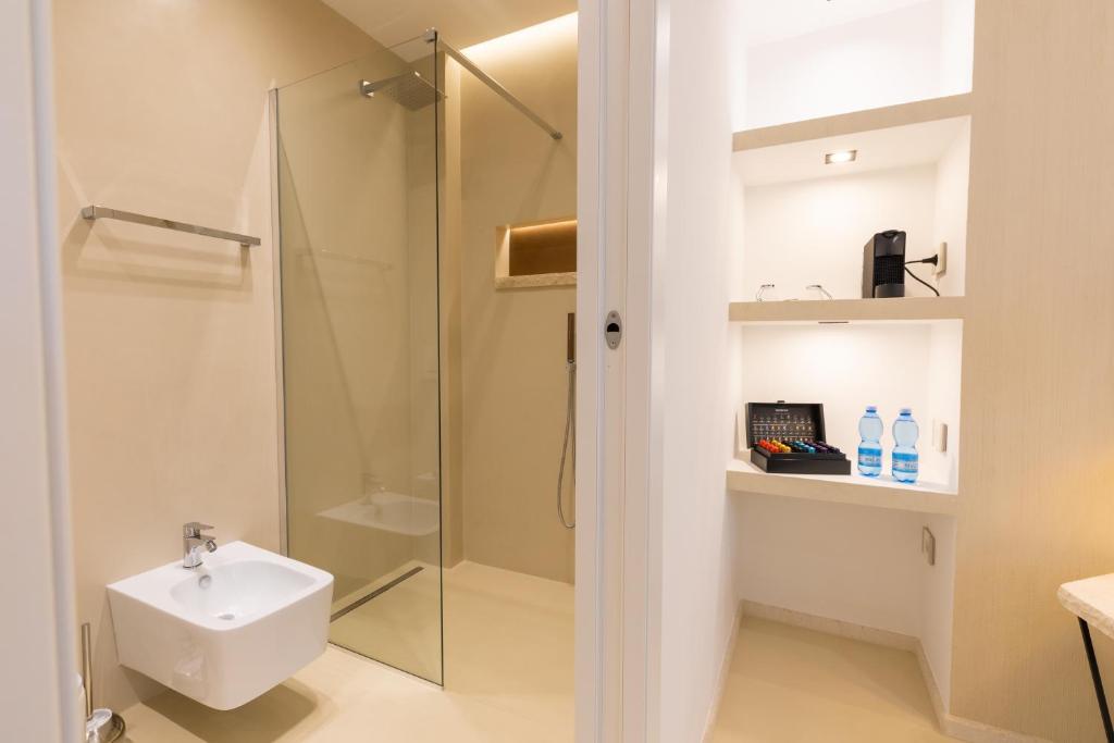 a bathroom with a shower and a toilet and a sink at Double A Luxury Room in Olbia