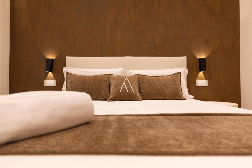a bedroom with a large white bed with two lamps at Double A Luxury Room in Olbia