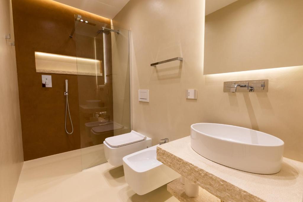 a bathroom with a sink and a toilet at Double A Luxury Room in Olbia