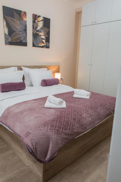 Postel nebo postele na pokoji v ubytování Galaxy Apartments
