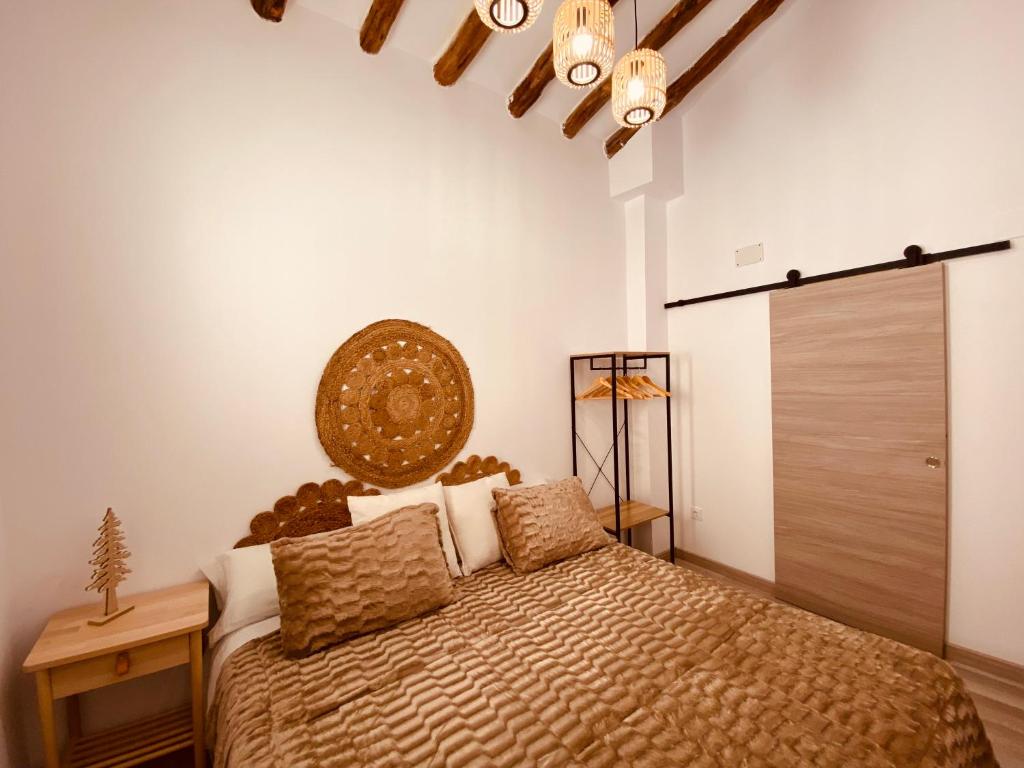 a bedroom with a bed with a large headboard at Apartamentos Casa Anselmo EL TERRAO 