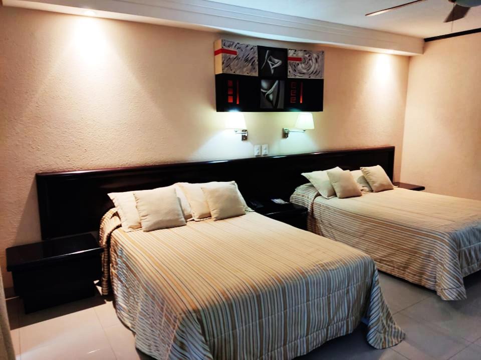 Postel nebo postele na pokoji v ubytování Hotel Mary Celaya