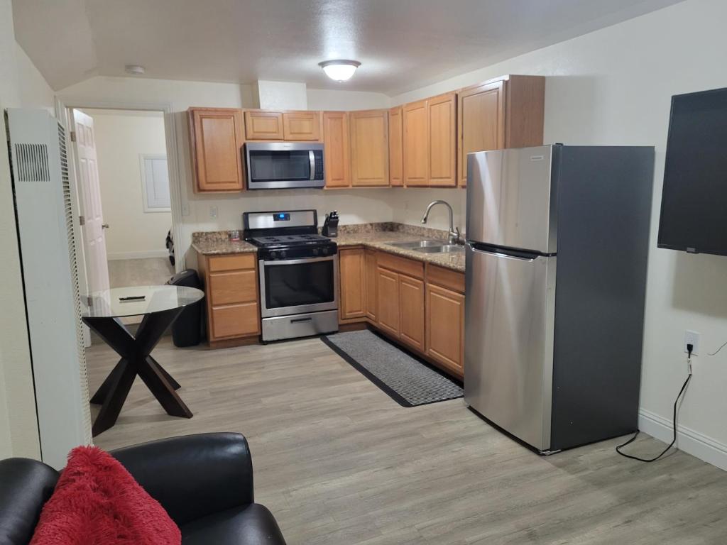 a kitchen with a stainless steel refrigerator and wooden cabinets at Adorable 1 bedroom Apartment in Vallejo