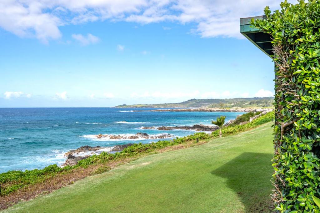 a golf course with a view of the ocean at K B M Resorts KBV-28G2 - Expansive 1500ft retreat, large balcony, jaw-dropping views, steps from beach in Kapalua