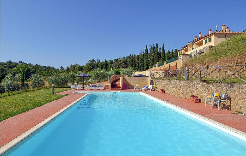 uma grande piscina azul ao lado de um edifício em Beautiful Apartment In Bucine With Outdoor Swimming Pool em Bucine