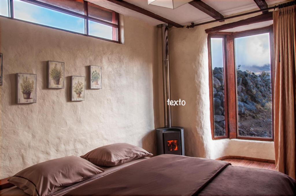 Postel nebo postele na pokoji v ubytování Hotel Tambopaxi