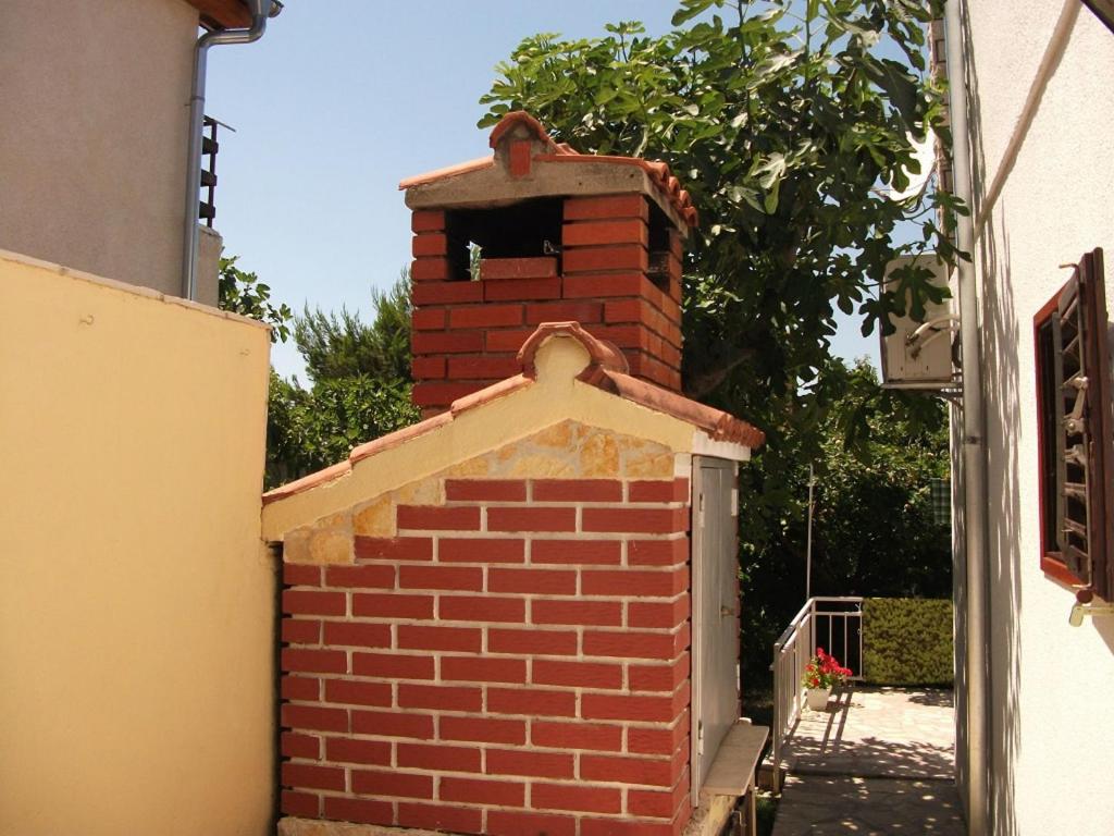 a brick oven with a window on top of it at Apartment Dusko - free parking in Gornji Karin