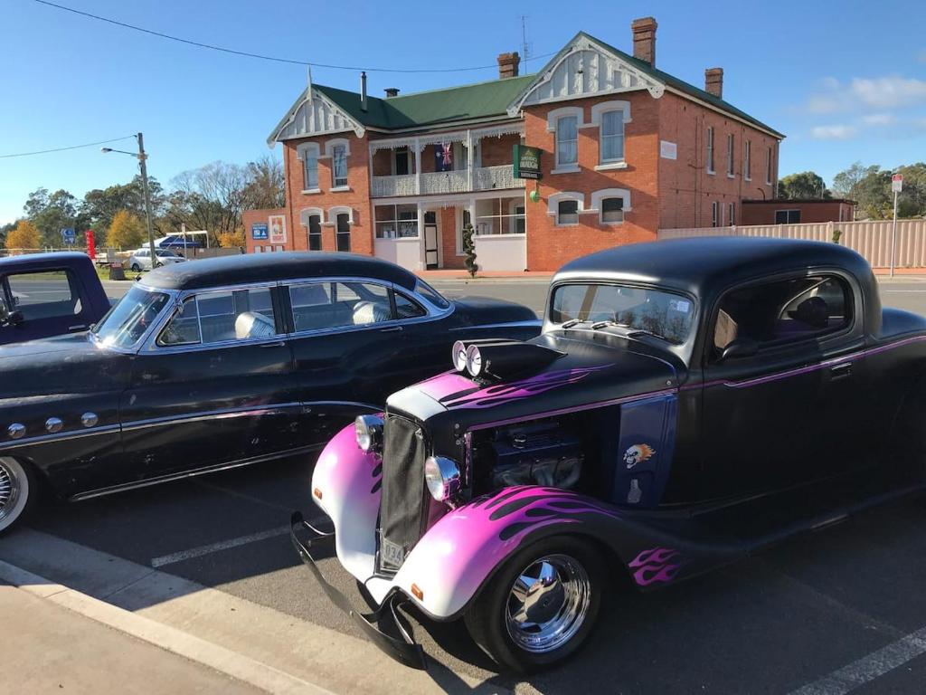 two old cars parked in a parking lot at Railton Hotel in Railton