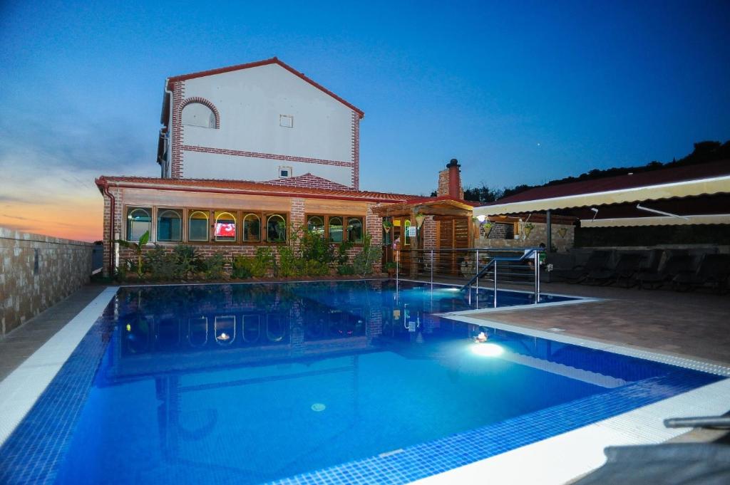 a swimming pool in front of a house at Apartments NATALI - with swimming pool in Novalja