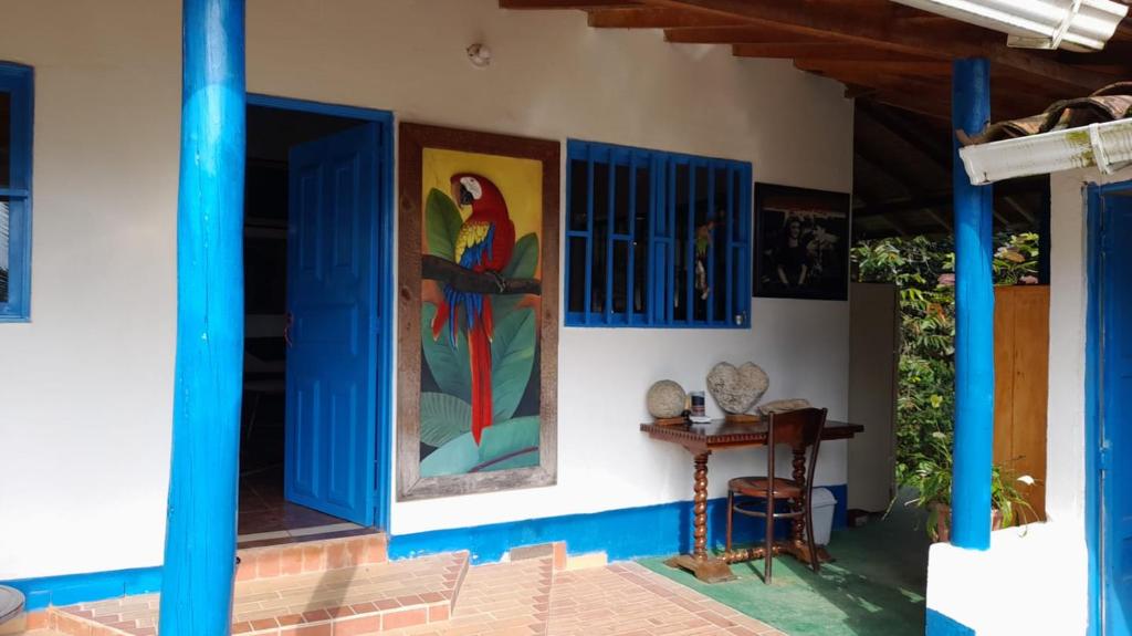 a house with a painting of a parrot on the wall at Casa Horizontes in San Carlos