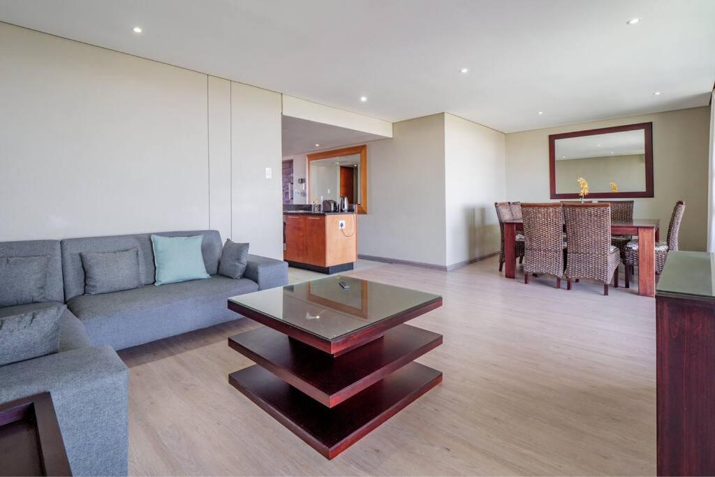 a living room with a couch and a table at Executive apartment at Ushaka Marine in Durban