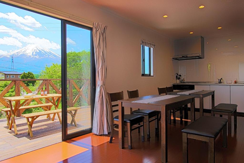 a kitchen and dining room with a view of a mountain at Fujinokura Village B - Vacation STAY 84882 in Fujikawaguchiko