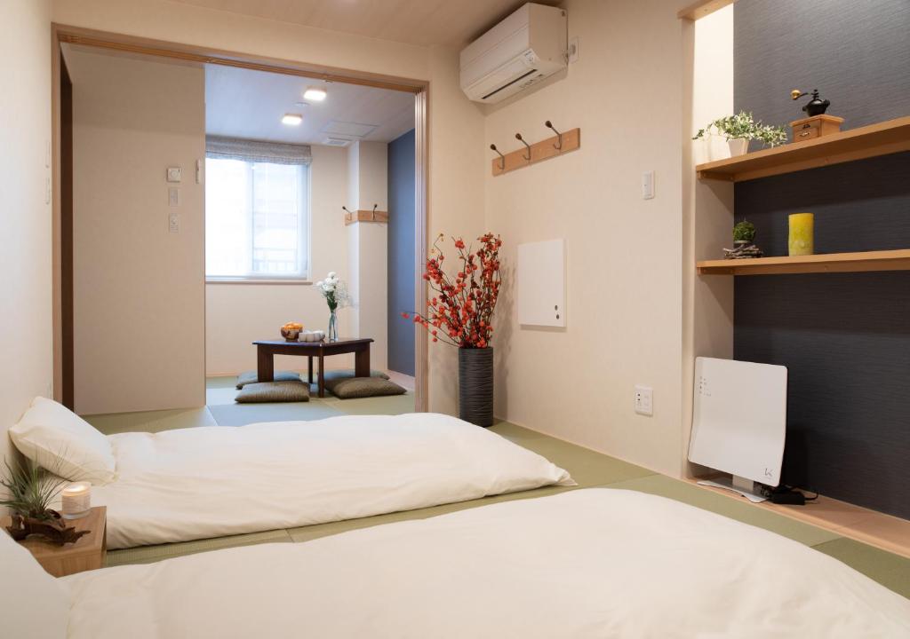 Postel nebo postele na pokoji v ubytování Miidokoro House Hotel