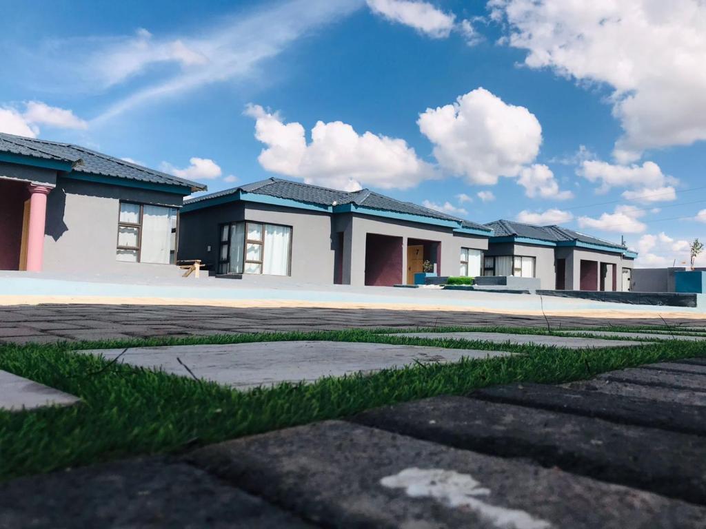 a row of houses with grass in front of them at RMB Luxury Lodge in Ga-Mothiba