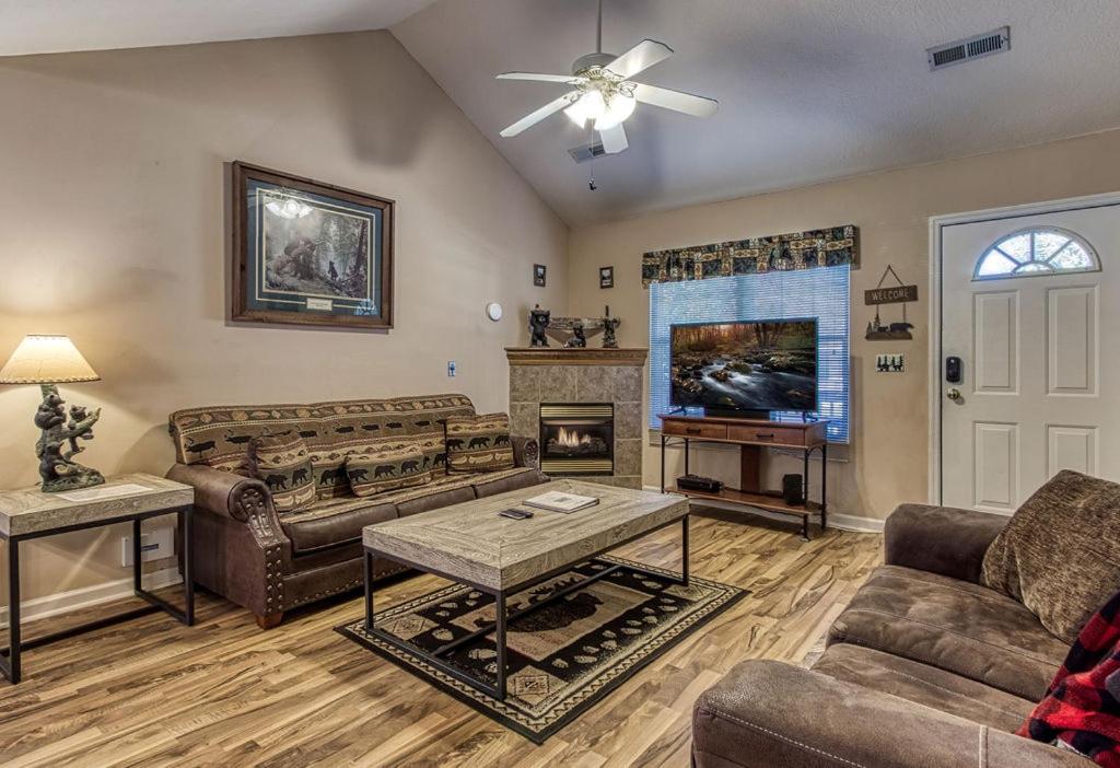 a living room with couches and a fireplace at Rock of Ages in Pigeon Forge