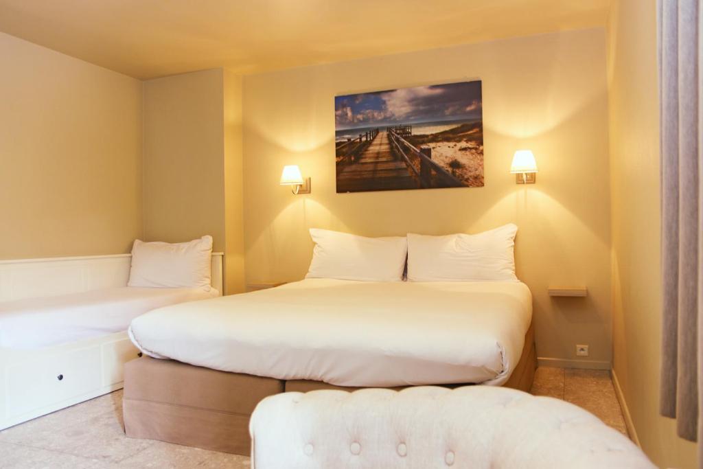 Postel nebo postele na pokoji v ubytování Hotel Les Dunes