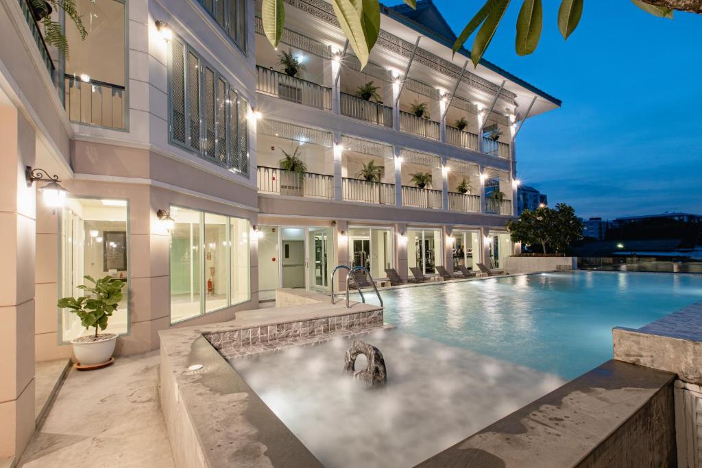 a swimming pool in the middle of a building at Siam Tharadol SHA Extra Plus in Bangkok