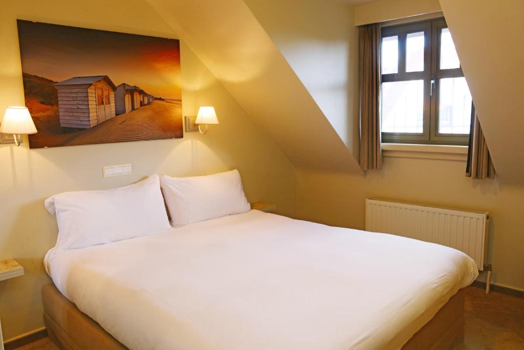 Postel nebo postele na pokoji v ubytování Hotel Les Dunes