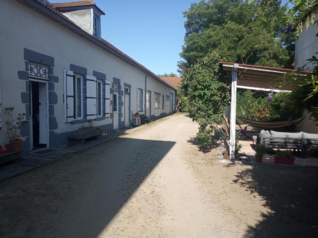 an empty dirt road next to a building at Au tournebride in Randan