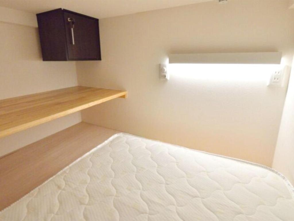 Postel nebo postele na pokoji v ubytování ゲストハウス岐阜羽島心音 Guest House Gifuhashima COCONE
