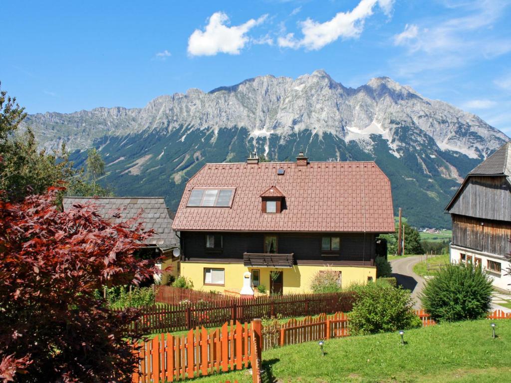 a house with a mountain in the background at Holiday Home Landhaus Prieger - OBL100 by Interhome in Öblarn